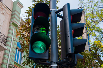 New modern traffic light in the city with a timer showing the seconds remaining. Street background....