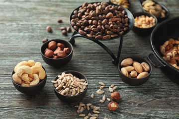 Composition with different nuts on wooden background