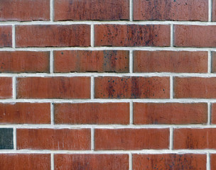 Background. Wall of red brick. White mix.