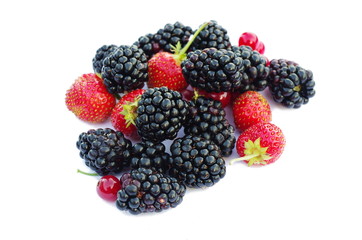 Fresh berries fruits with strawberries, blackberries, red currants on white background. Summer berries mix