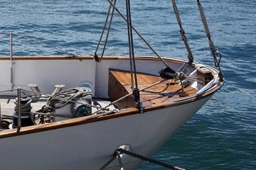 Bow of a white sailing yacht  against the blue sea