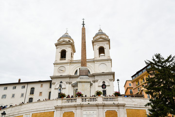 Obraz premium ローマ市内の古代遺跡（イタリア） スペイン階段の上のオベリスク（サルスティアーノ・オベリスク）と教会（トリニタ・デイ・モンティ教会）