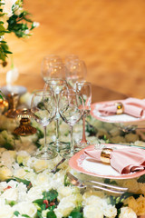 Sparkling glassware stands on table prepared for elegant wedding