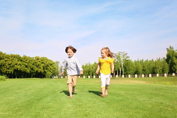 Obraz premium Cute little children running in park on sunny day