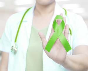 Doctor with lime green ribbon awareness for Lyme Disease,Lymphoma,Muscular Dystrophy, National Wise Mental Health Consumer Month
