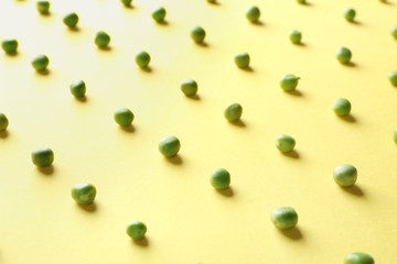 Fresh green peas on color background