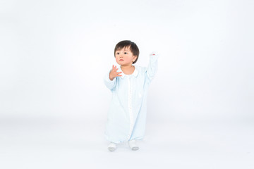 Infant child baby girl kid toddler in diaper make first steps isolated on a white background