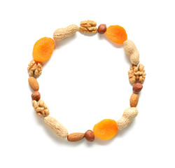 Frame made of different nuts and dried apricots on white background