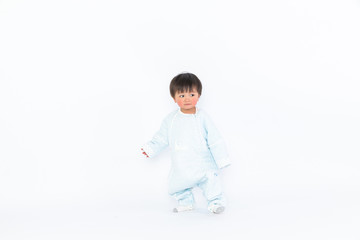 Infant child baby girl kid toddler in diaper make first steps isolated on a white background
