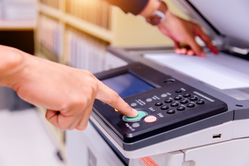 Bussiness man Hand press button on panel of printer, printer scanner laser office copy machine supplies start concept.
