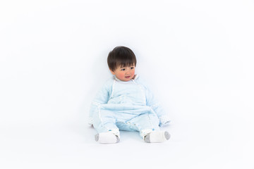 beautiful little baby sits on the floor isolated on white background