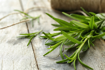 Fresh rosemary on wooden background, closeup