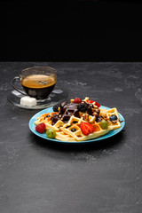 Photo of cup of coffee with Belgian wafers with strawberries, raspberries