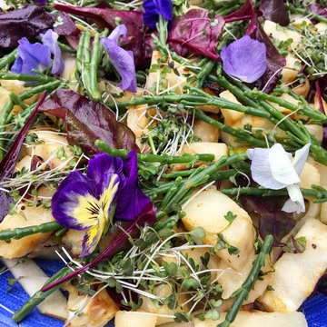 Baked celeriac with samphire and edible flowers