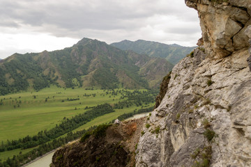 View from the top of the Altai mountains to the river and hill in Siberia with plants and trees
