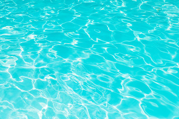 Abstract of blue water surface in swimming pool, Ripple wave in pool with sun reflections