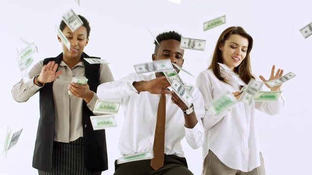 Studio shot of rich Caucasian and black businesspeople making it rain money isolated on light background