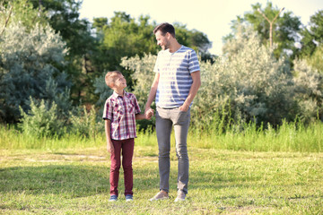 Father and son in park on summer day