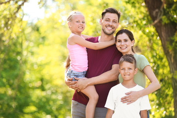 Fototapeta premium Happy family in green park on summer day