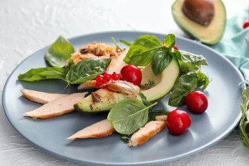 Tasty grilled chicken fillet and vegetables on plate, closeup