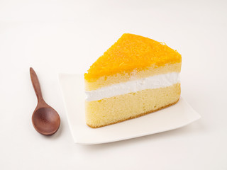 Orange cake in white dish on white background