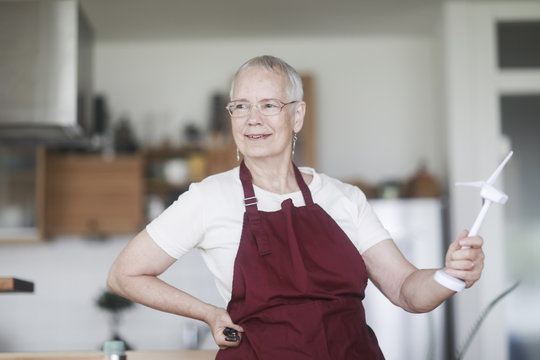 Smiling Woman Holding An Electric Fan That She's Fixed