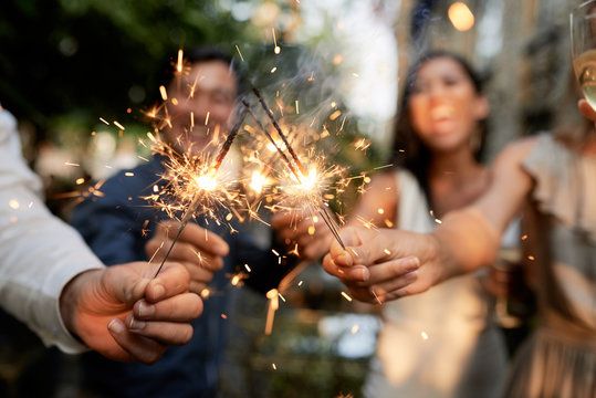 Friends with burning sparklers