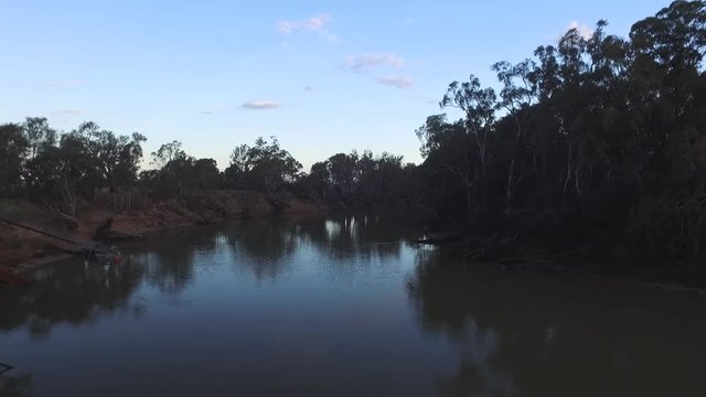 Drone aerial view of The Murray River low down close to the water. Cadell New South Wales, Australia. Blue sky clouds.
