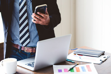 e commerce online on mobile phone screen with businessman work in the office, The media reaches the...