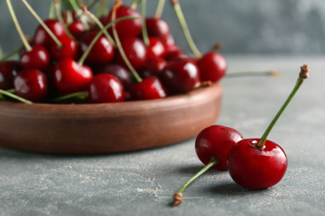 Sweet cherries on grey textured table