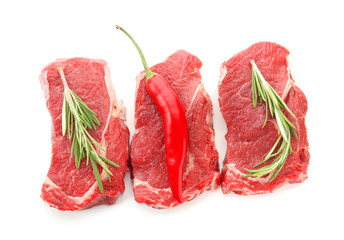 Raw meat with fresh spices on white background