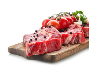 Fresh raw meat with spices and tomatoes on white background