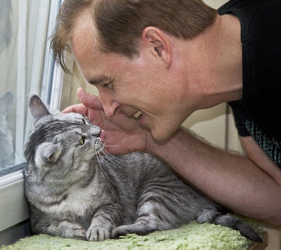 Man playing with a cat
