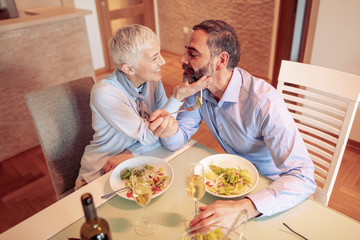 Mature couple having lunch together at home