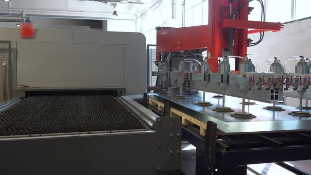 High-tech industrial production, positioning of a metal sheet ready to be cut with CNC laser cutting machine