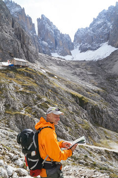 Hiker reading map, Canazei, Trentino-Alto Adige, Italy