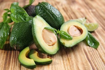 Fresh ripe avocados on wooden background