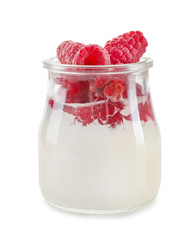 Glass jar with tasty raspberry dessert on white background