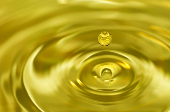 Golden water droplet splashing in water