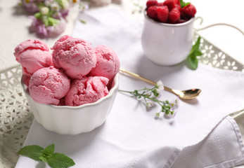 Bowl with delicious raspberry ice-cream on table