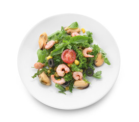 Tasty salad with seafood and vegetables on plate against white background