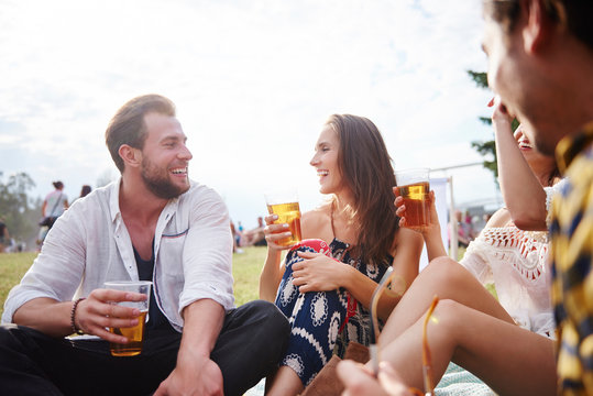 Friends sitting and enjoying music festival