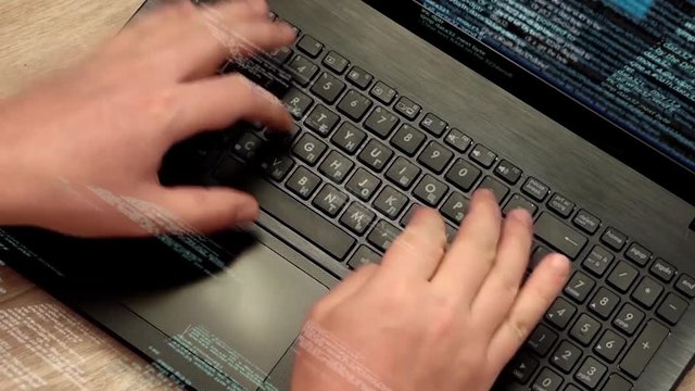 Programmer at work - Caucasian man hands typing on laptop keyboard, elements of software code running on screen and flying in the air. Hacker or coder working with notebook.
