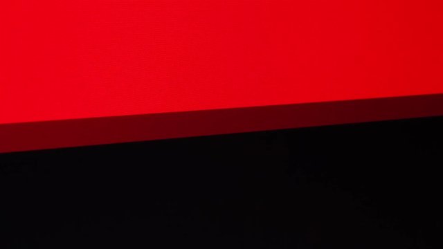 A flashing text, Porn, on a red and black background on an LCD computer screen. Angled shot.
