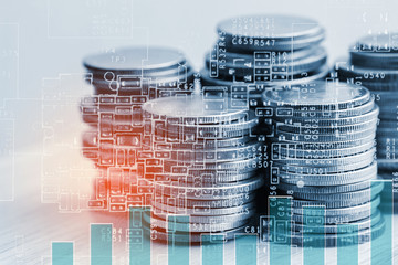 Stack of coins with growing graph for business finance concept