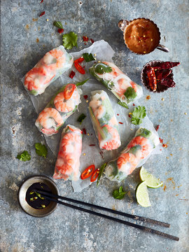 Prawn rolls on rice paper and pair of chopsticks