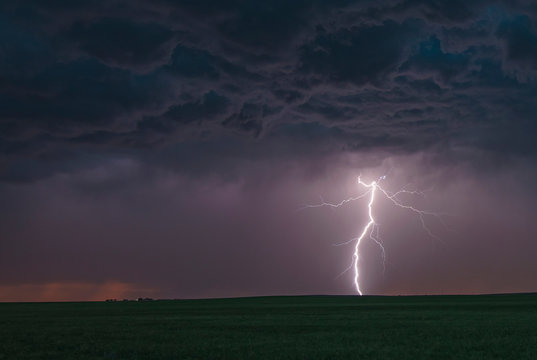 Forked cloud-to-ground lightning bolt hits rural terrain, Ogallala, Nebraska, US