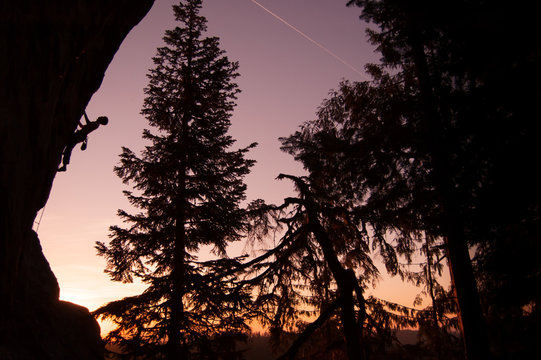 Silhouette of rock climber rock climbing at sunset, Flagstone, Eugene, Oregon, United States