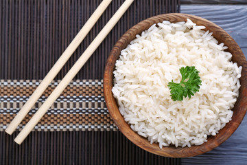 Bowl with boiled white rice on table