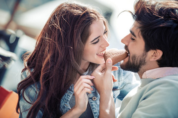 Obraz na płótnie Canvas Romantic young couple share cookie